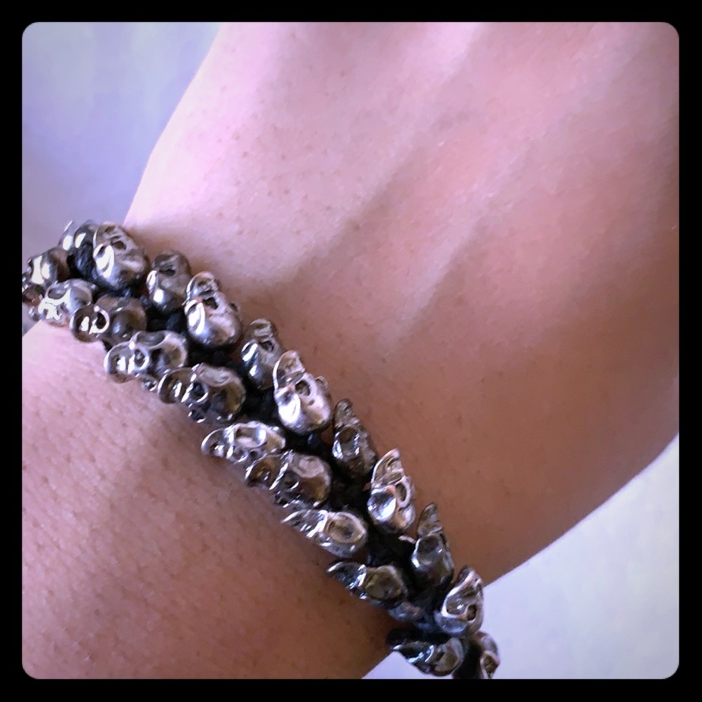 Black bracelet with silver plated skulls